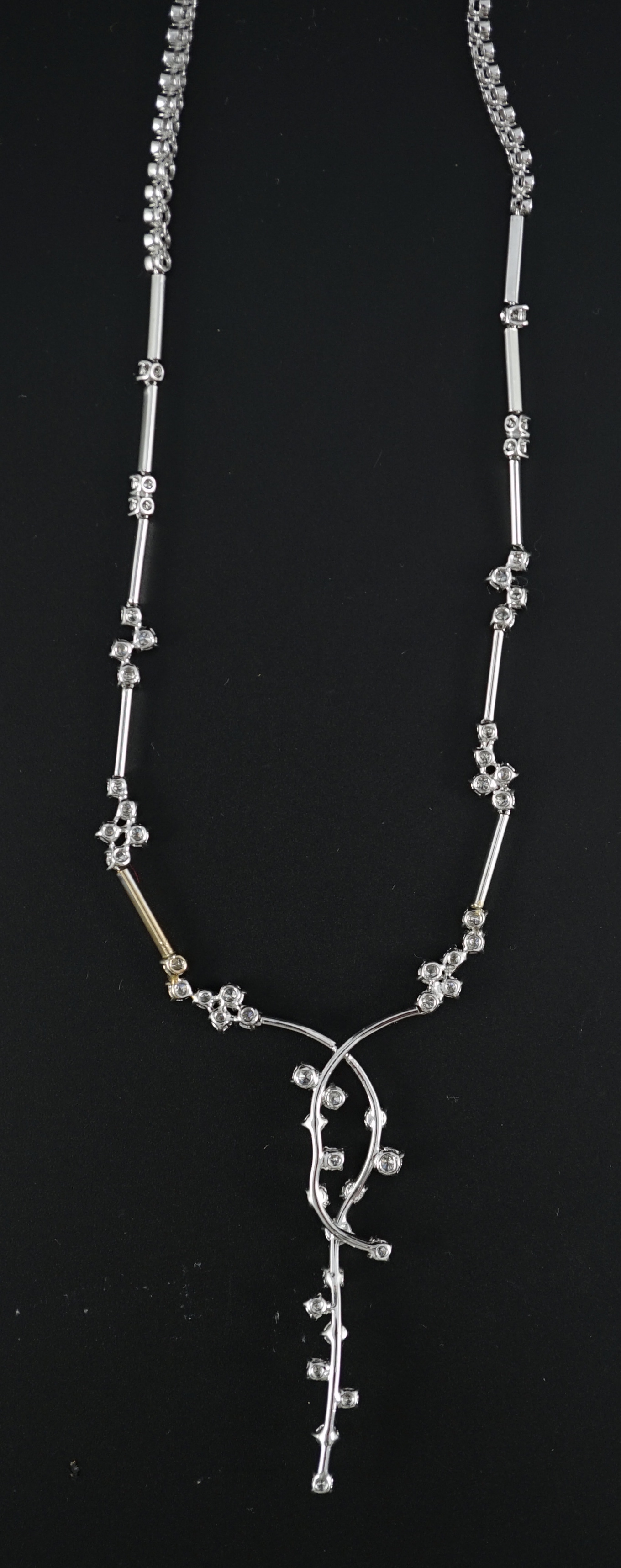 A modern 18k white gold and diamond cluster set necklace